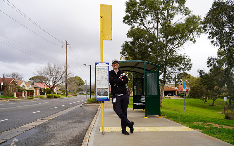 Cassie-Hames-leaning-on-a-bus-stop-near-Tonsley