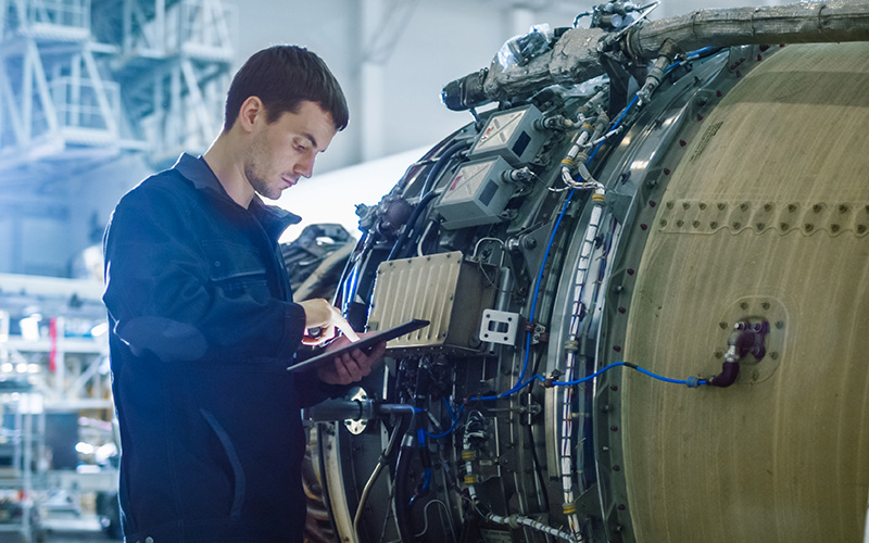 Engineer-working-on-plane-engine-airport