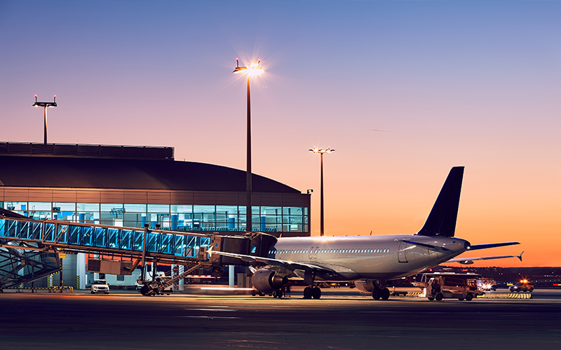 Plane-landed-at-airport-terminal-visible-in-background