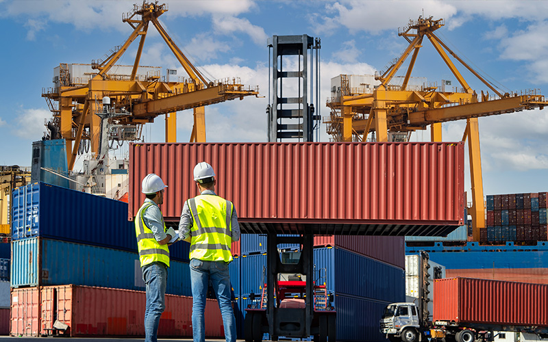 two-port-workers-assessing-a-shipping-container